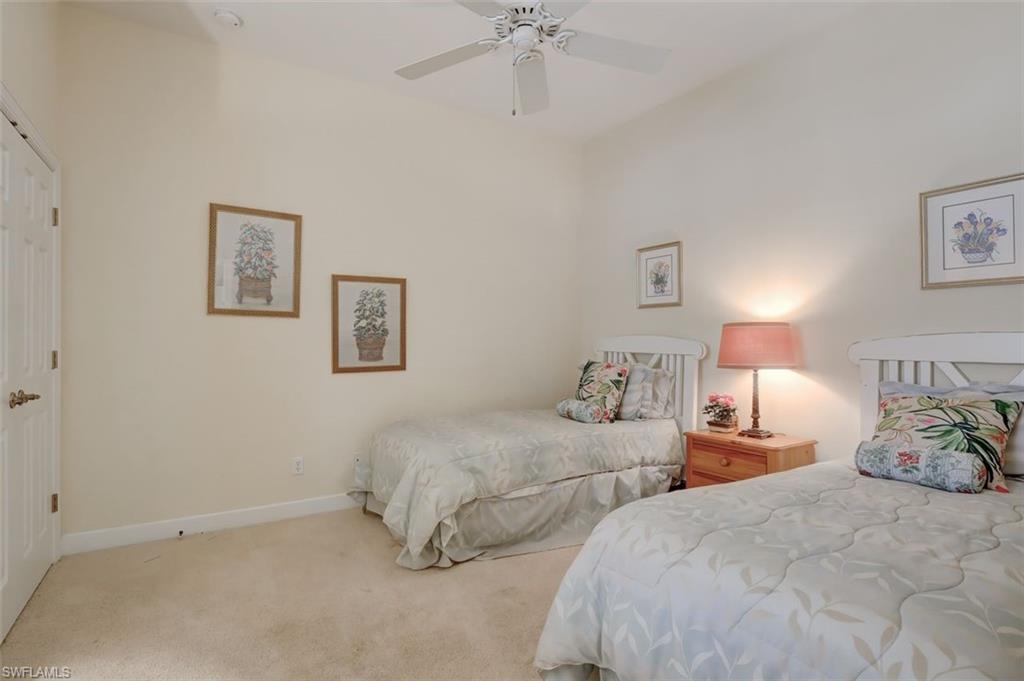 16092 Parque Lane Naples, FL 34110 - Photo 12 of 35 a bedroom with two bed and a chandelier