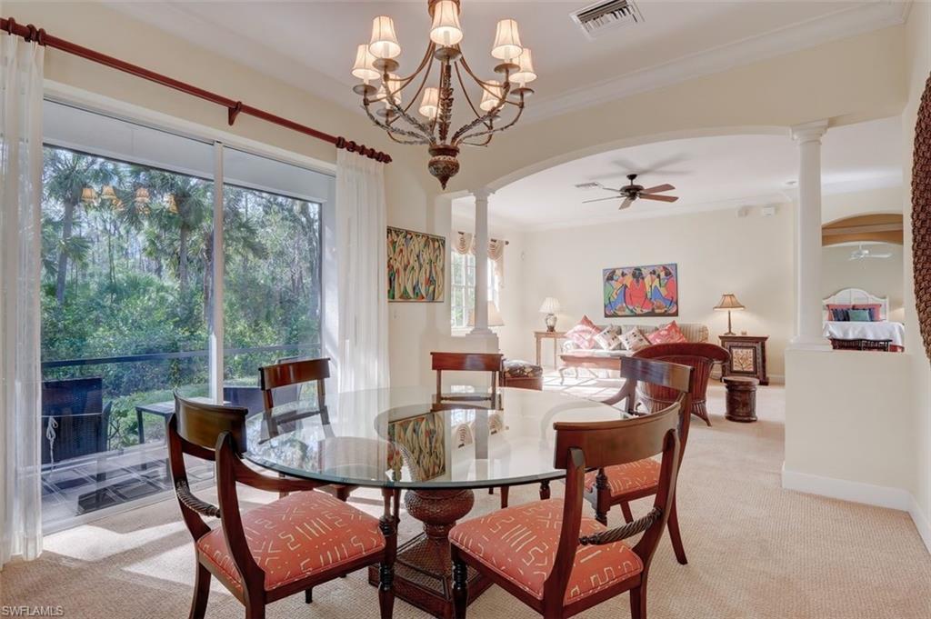 16092 Parque Lane Naples, FL 34110 - Photo 14 of 35 a dining room with furniture a large window and a chandelier