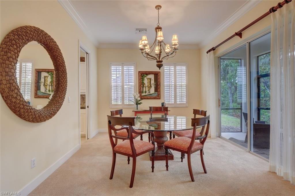16092 Parque Lane Naples, FL 34110 - Photo 16 of 35 a view of a dining room with furniture and a chandelier