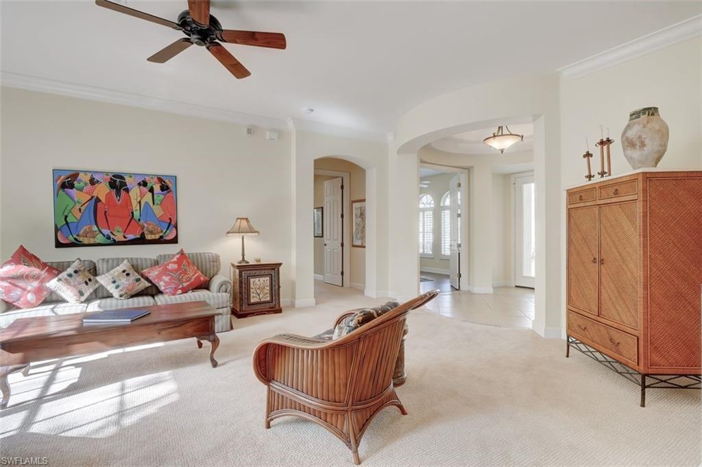 16092 Parque Lane Naples, FL 34110 - Photo 19 of 35 a living room with furniture and a flat screen tv
