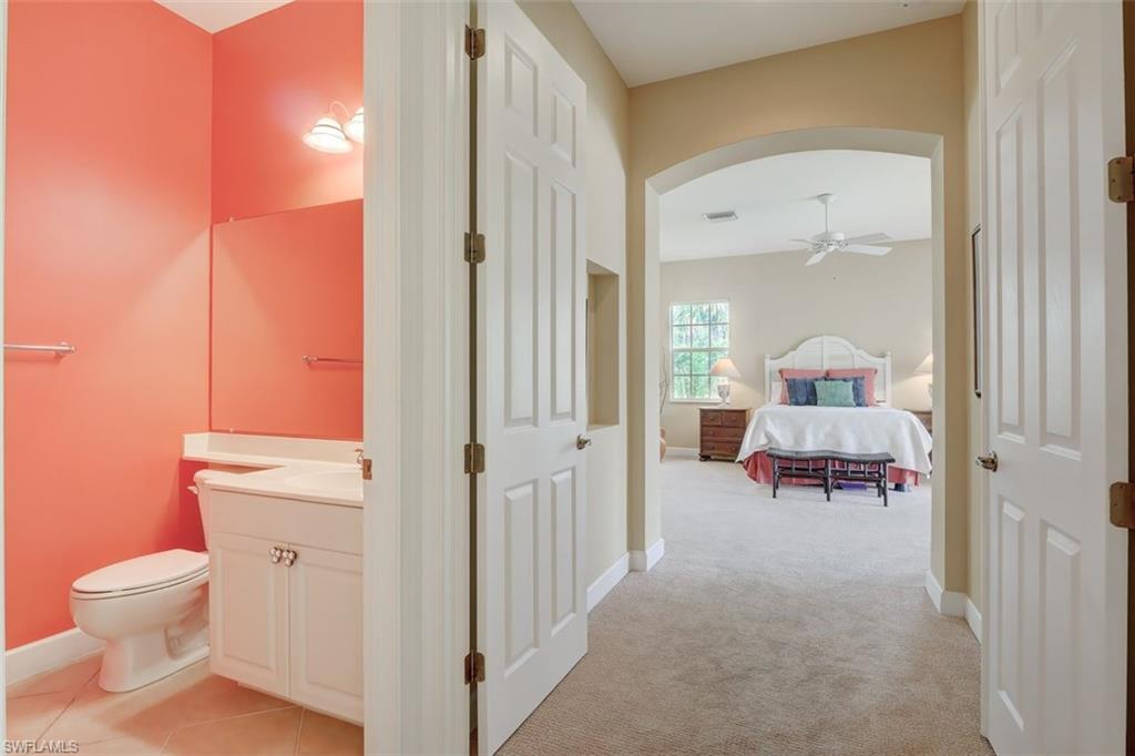 16092 Parque Lane Naples, FL 34110 - Photo 24 of 35 a view of a room with wooden floor and a bathroom