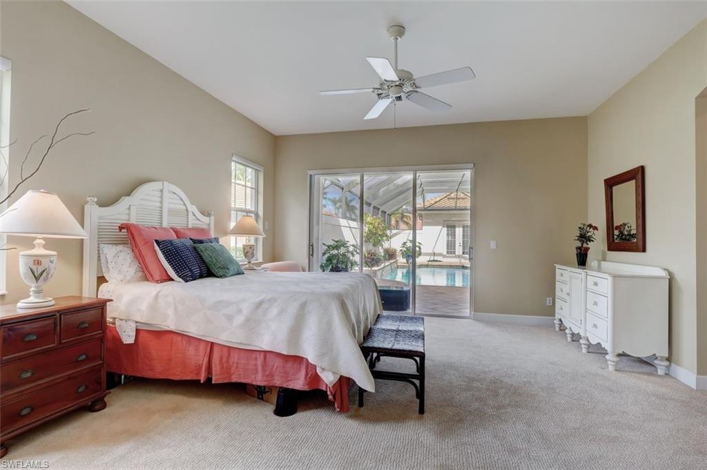 16092 Parque Lane Naples, FL 34110 - Photo 27 of 35 a bedroom with a bed and a chandelier