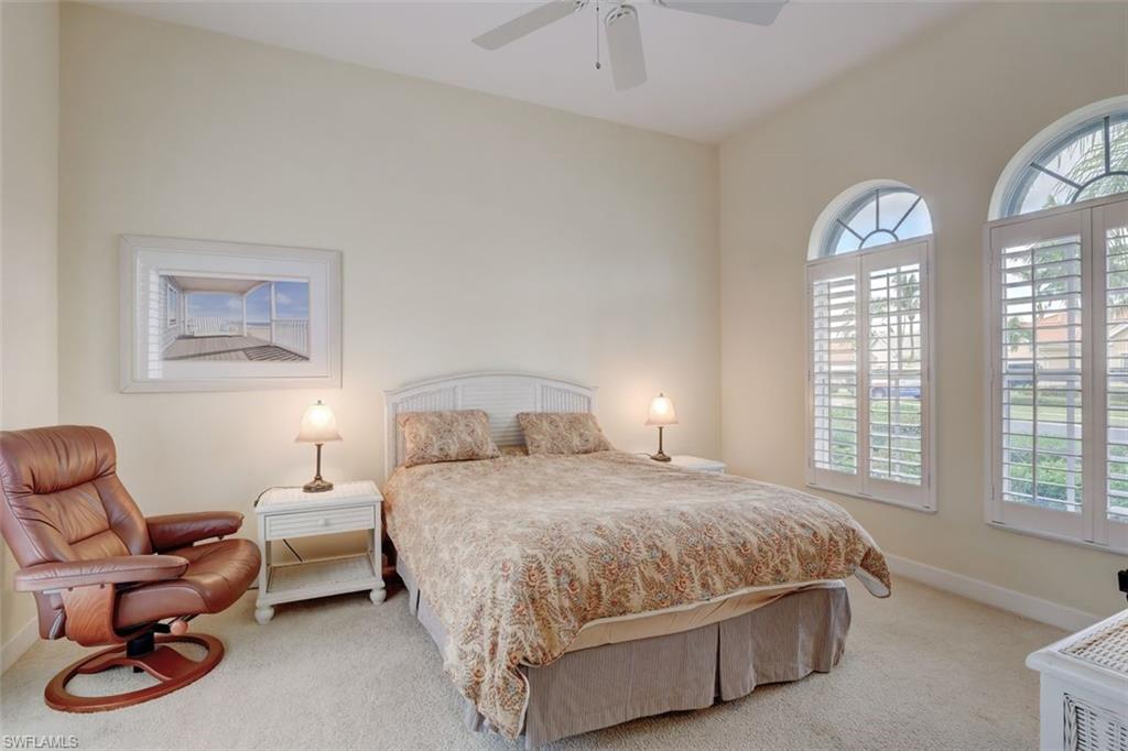 16092 Parque Lane Naples, FL 34110 - Photo 31 of 35 a bedroom with a bed chair and window