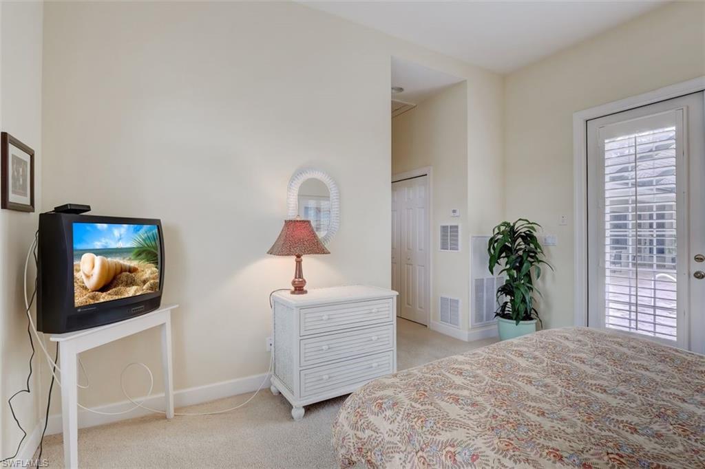 16092 Parque Lane Naples, FL 34110 - Photo 32 of 35 a bedroom with a bed and a flat screen tv