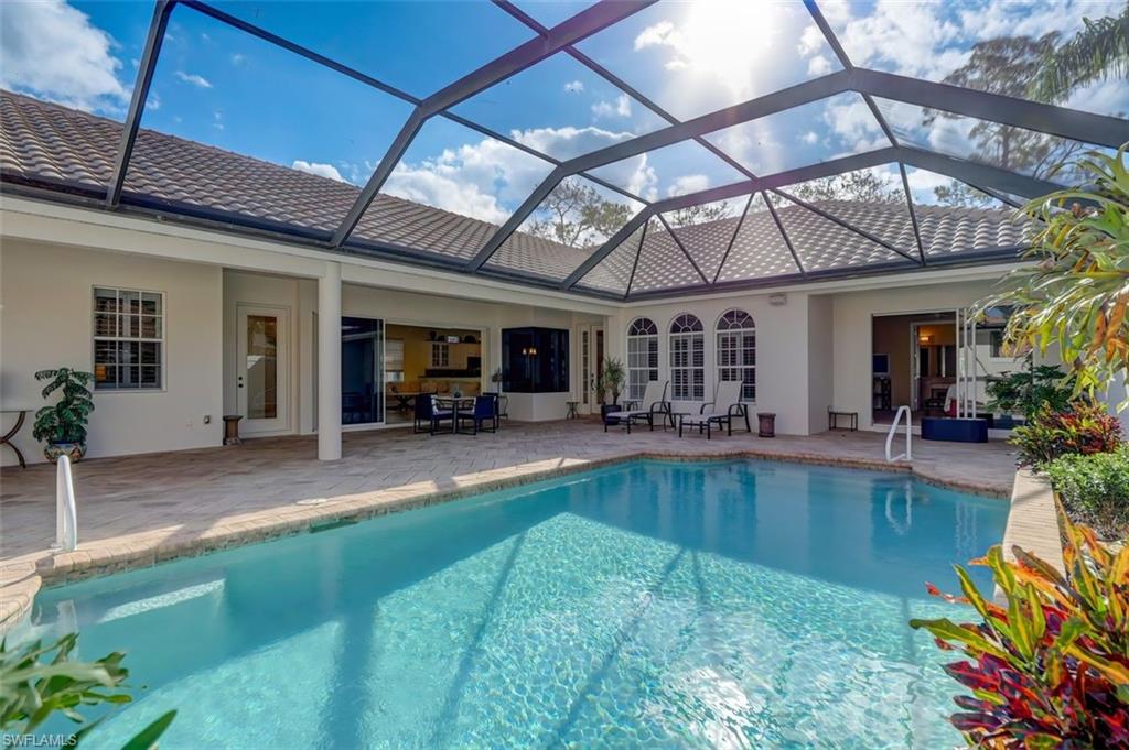 16092 Parque Lane Naples, FL 34110 - Photo 4 of 35 a view of a swimming pool with a patio