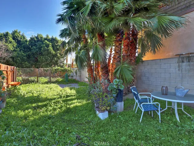 a backyard of a house with table and chairs