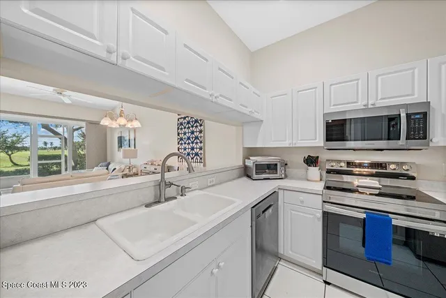 a kitchen with stainless steel appliances a stove sink microwave and cabinets