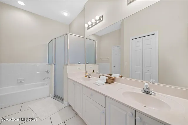 a spacious bathroom with a bathtub shower sink double and mirror