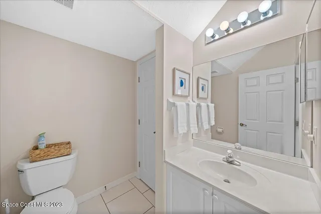 a bathroom with a sink a toilet a mirror and shower
