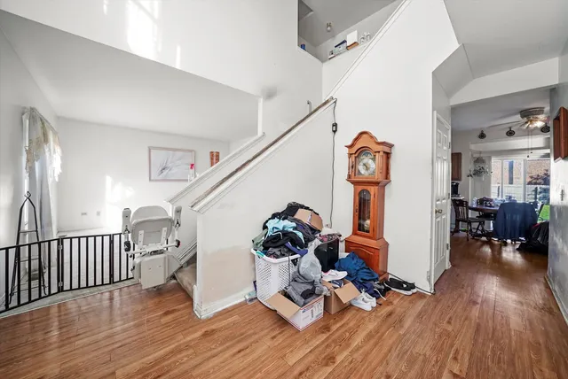 a view of entryway with wooden floor and stairs