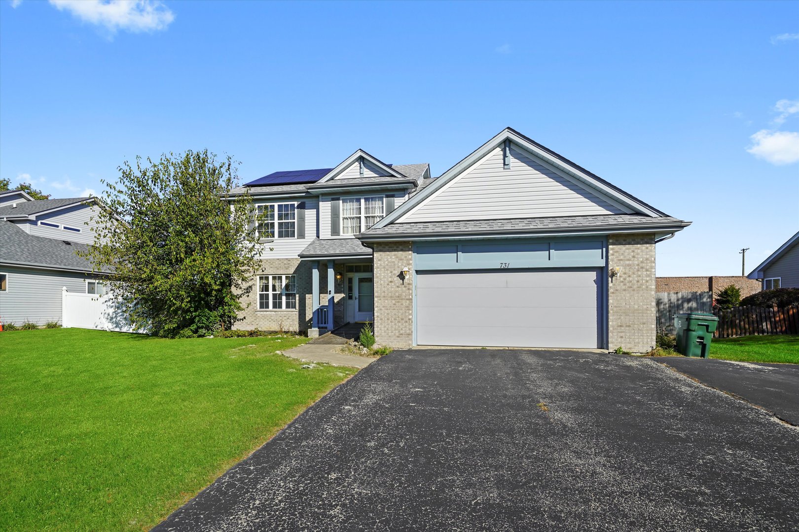 731 Bobwhite Lane New Lenox, IL 60451 - Photo 21 of 26 a front view of a house with yard and garage