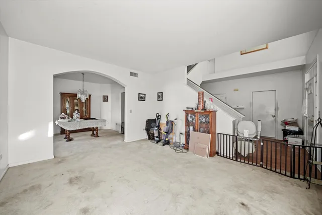 a dining room with furniture and a floor to ceiling window