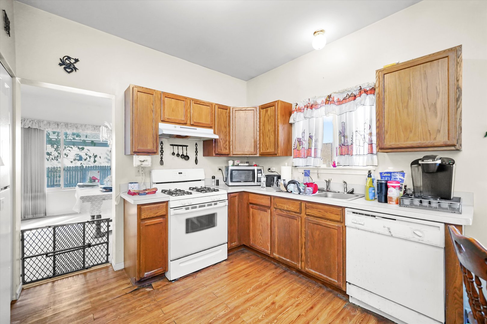 731 Bobwhite Lane New Lenox, IL 60451 - Photo 6 of 26 a kitchen with a sink cabinets appliances and a window