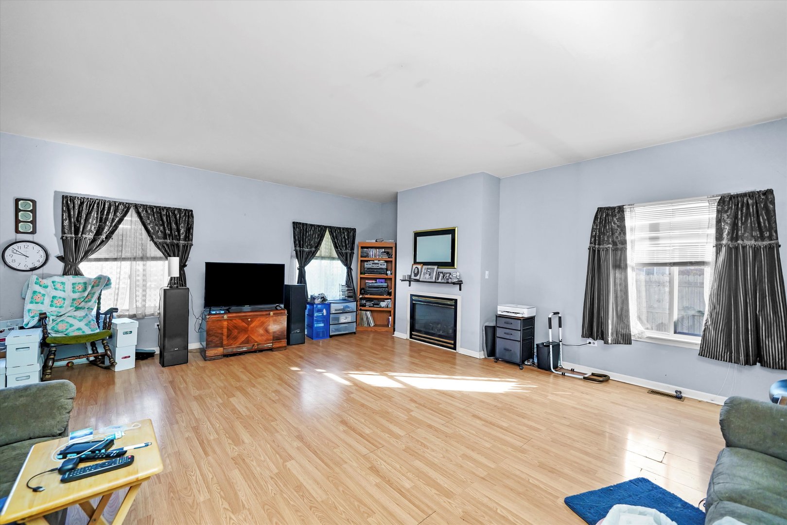 731 Bobwhite Lane New Lenox, IL 60451 - Photo 9 of 26 a living room with furniture a fireplace and a flat screen tv