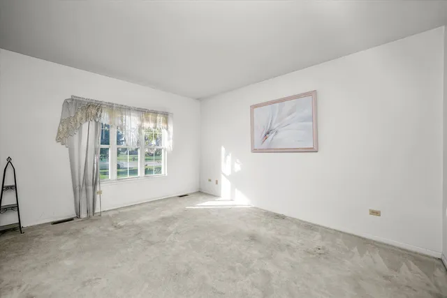 a spacious bathroom with a granite countertop sink mirror and bathtub