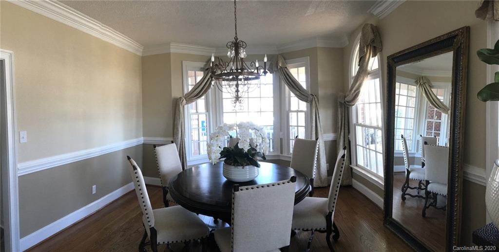 3215 Startown Road Lincolnton, NC 28092 - Photo 14 of 39 a dining room with furniture a chandelier and wooden floor