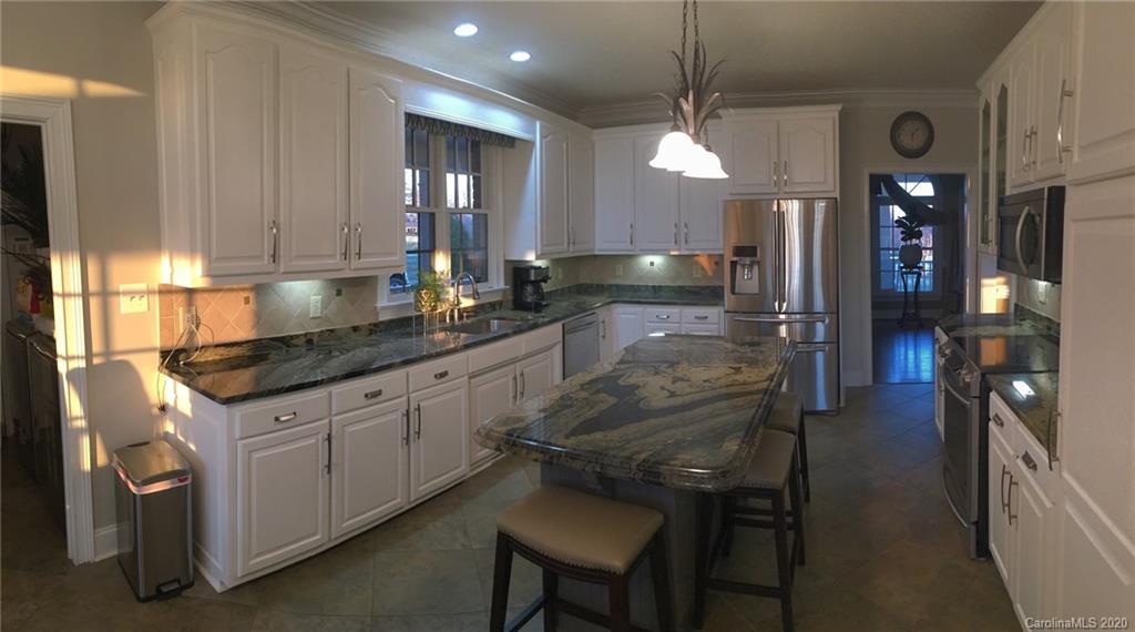 3215 Startown Road Lincolnton, NC 28092 - Photo 17 of 39 a kitchen with stainless steel appliances granite countertop a sink a stove and a refrigerator