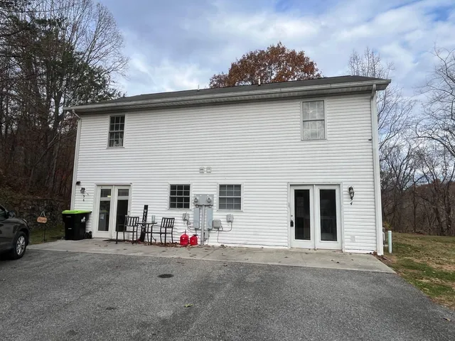 a front view of a house with a road