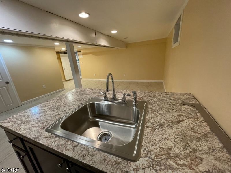 25 Bayview Avenue Newark, NJ 07112 - Photo 12 of 15 a kitchen with a sink and a refrigerator