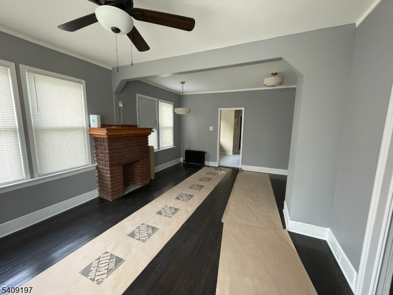 25 Bayview Avenue Newark, NJ 07112 - Photo 2 of 15 a hallway with a dresser and a window
