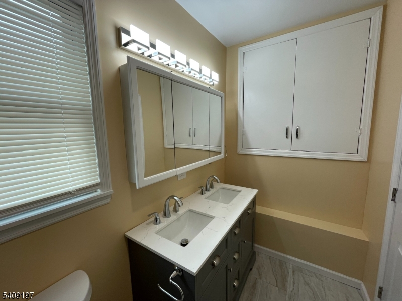 25 Bayview Avenue Newark, NJ 07112 - Photo 9 of 15 a bathroom with a sink and a mirror
