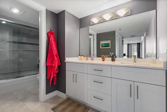 a bathroom with a sink vanity and a mirror