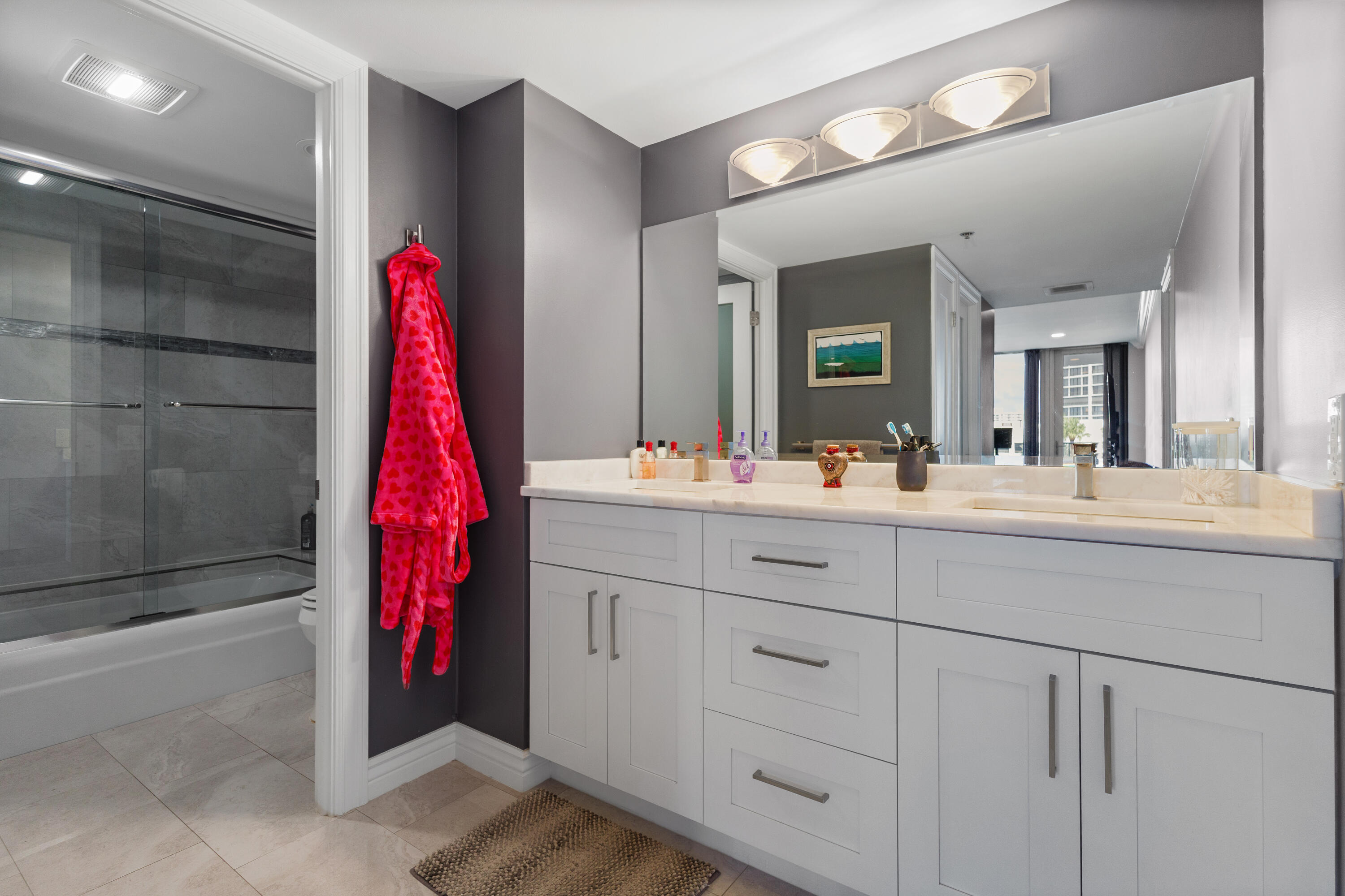 4750 South Ocean Boulevard, Unit 204 Highland Beach, FL 33487 - Photo 12 of 30 a bathroom with a sink vanity and a mirror