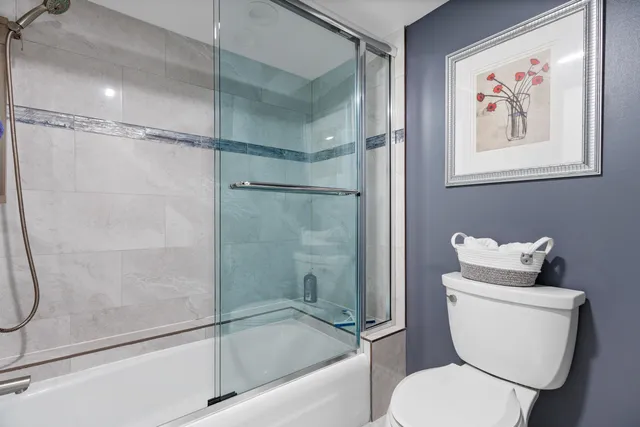 a bathroom with a toilet and a shower