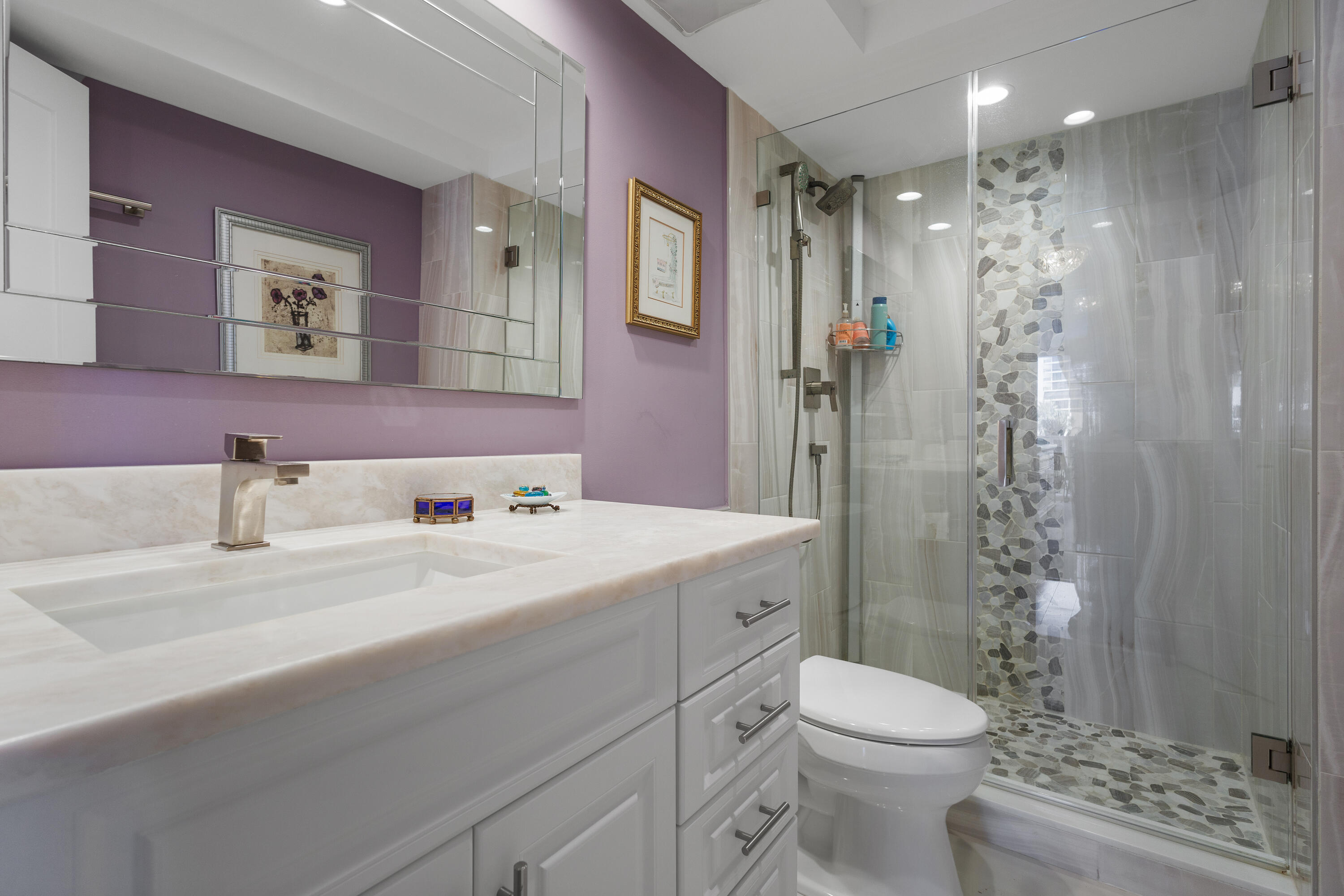4750 South Ocean Boulevard, Unit 204 Highland Beach, FL 33487 - Photo 15 of 30 a bathroom with a sink a toilet a shower and a mirror