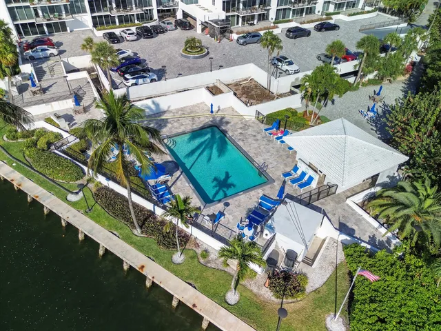 an aerial view of a house with a garden and lake view