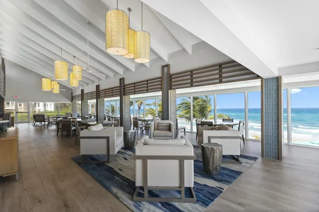 a living room with fireplace furniture and a large window
