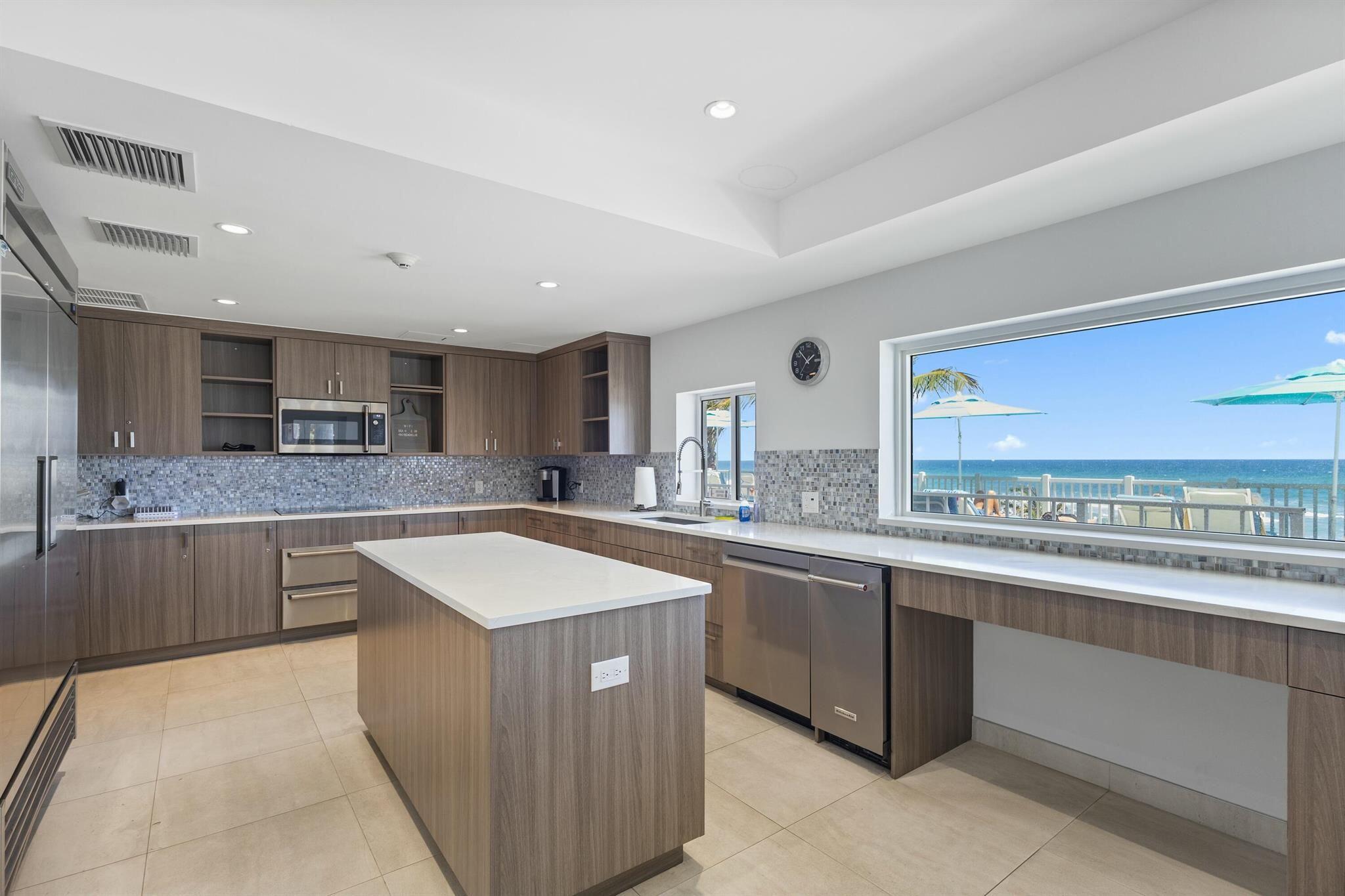 4750 South Ocean Boulevard, Unit 204 Highland Beach, FL 33487 - Photo 30 of 30 a kitchen with stainless steel appliances granite countertop a sink counter space cabinets and a large window