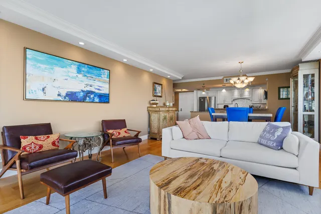 a living room with furniture and a chandelier