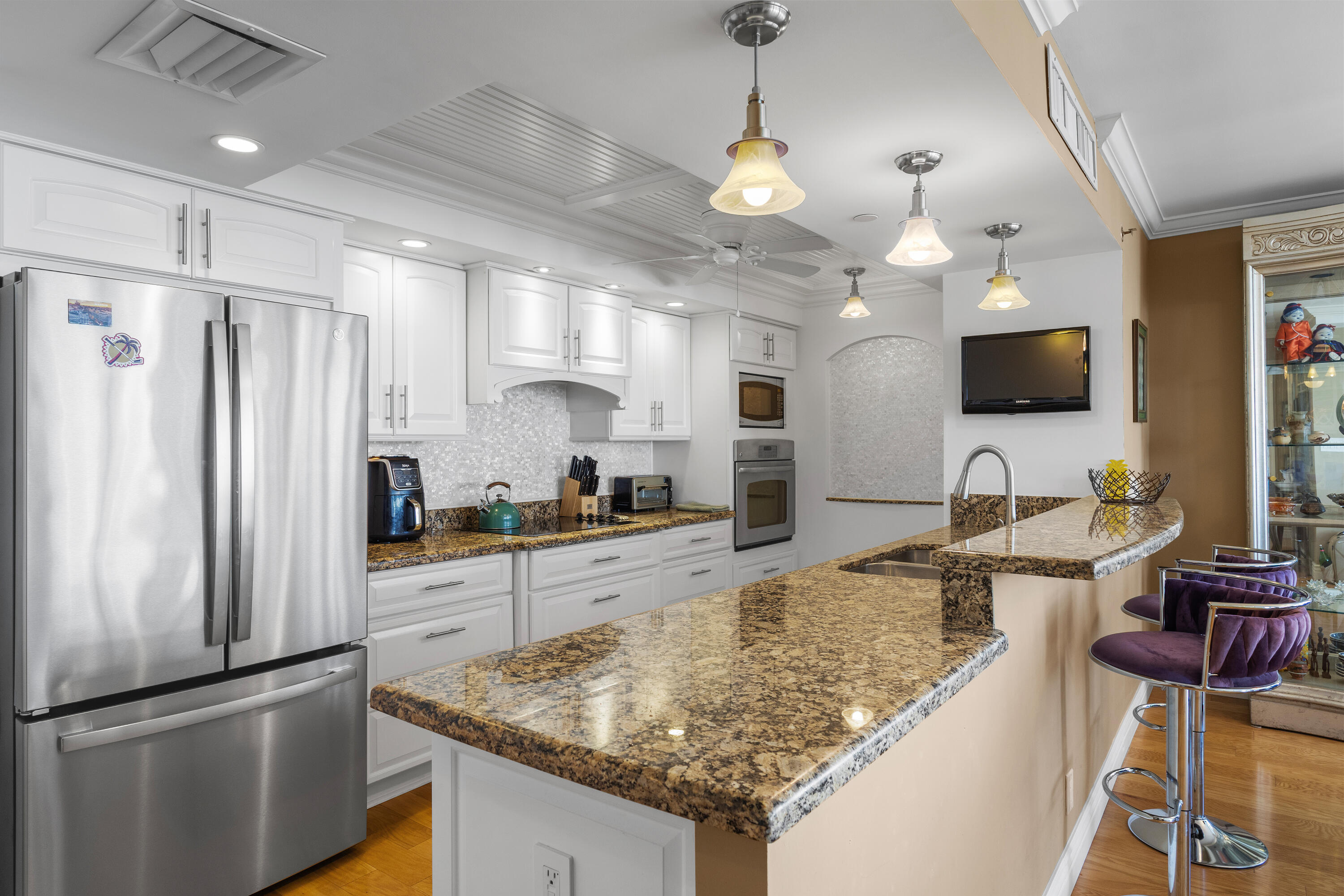 4750 South Ocean Boulevard, Unit 204 Highland Beach, FL 33487 - Photo 7 of 30 a kitchen with stainless steel appliances granite countertop a sink refrigerator and cabinets