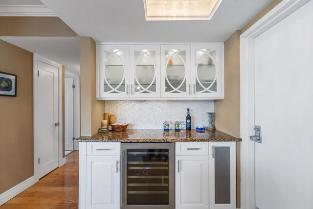 a kitchen with a refrigerator and cabinets