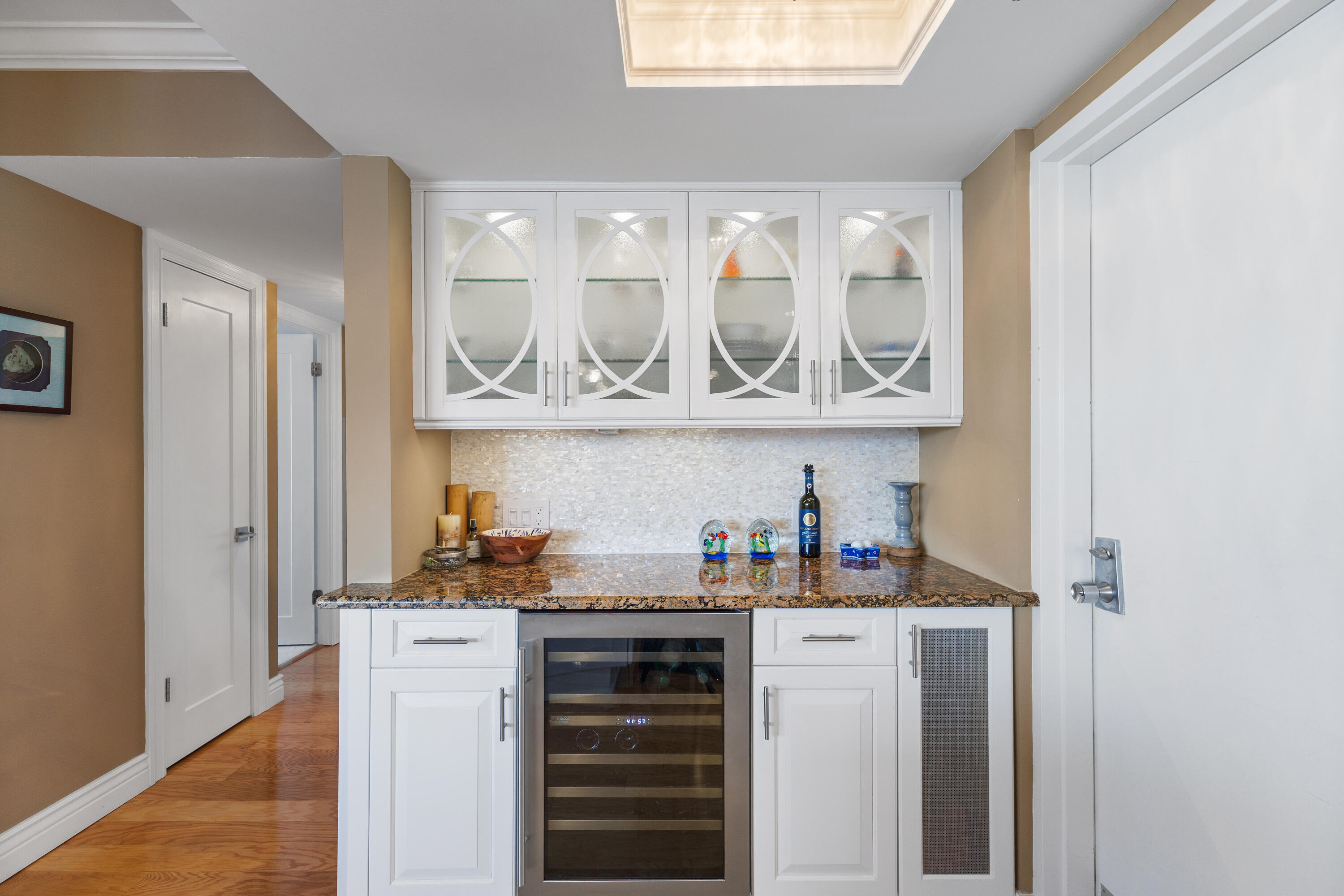 4750 South Ocean Boulevard, Unit 204 Highland Beach, FL 33487 - Photo 9 of 30 a kitchen with a refrigerator and cabinets