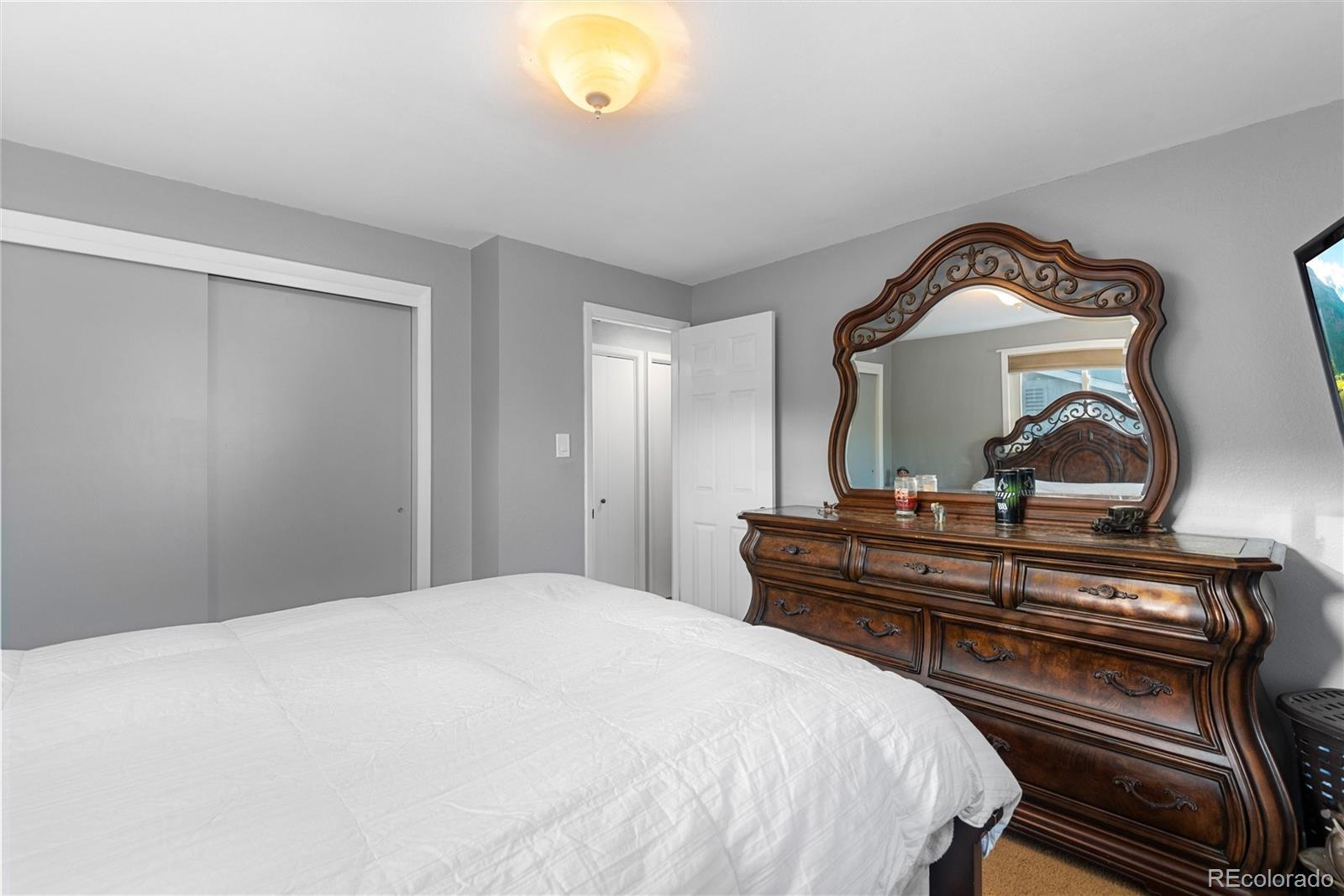4904 West 61st Drive Arvada, CO 80003 - Photo 16 of 37 a bedroom with a bed and a dresser