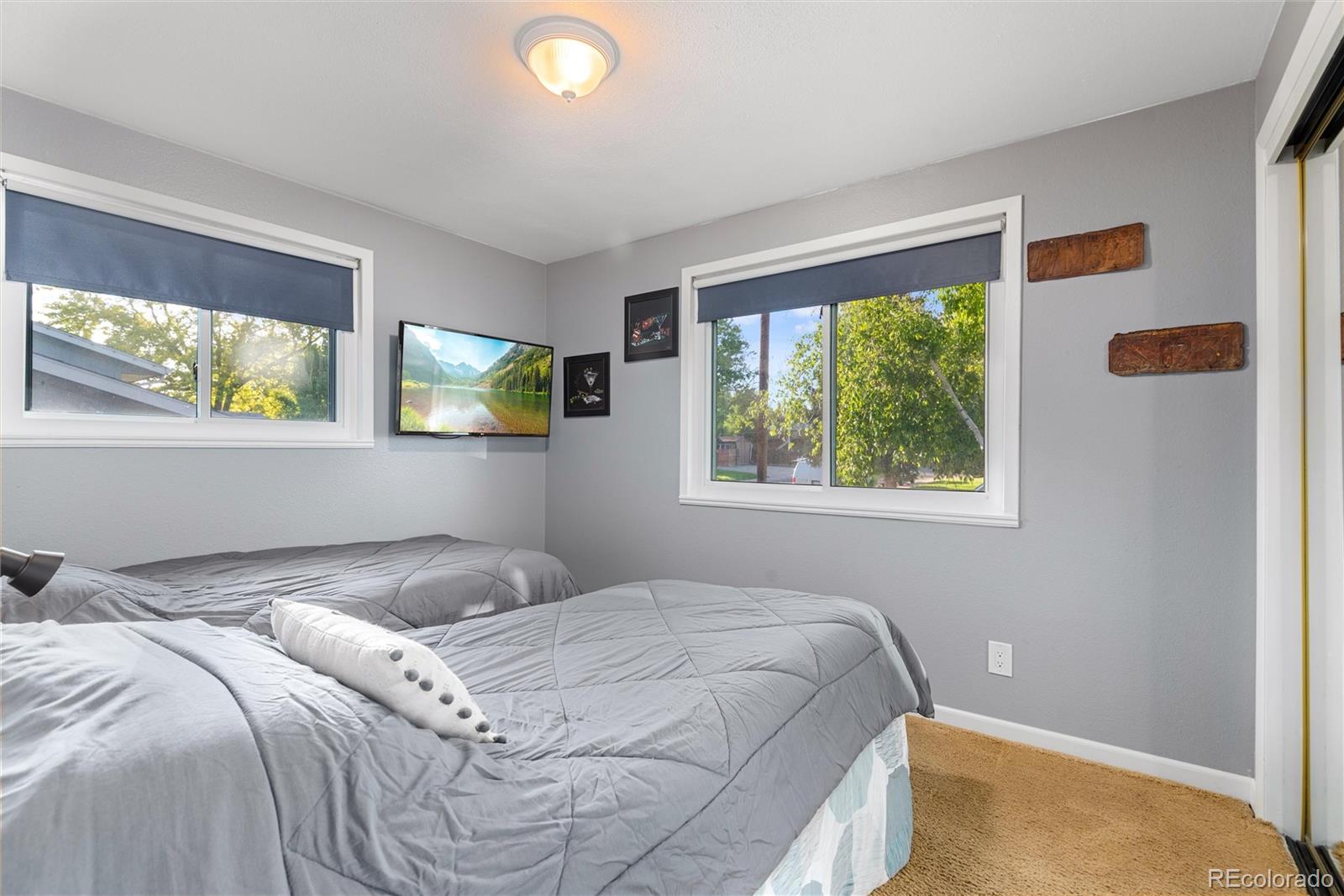 4904 West 61st Drive Arvada, CO 80003 - Photo 19 of 37 a bedroom with a bed and a window