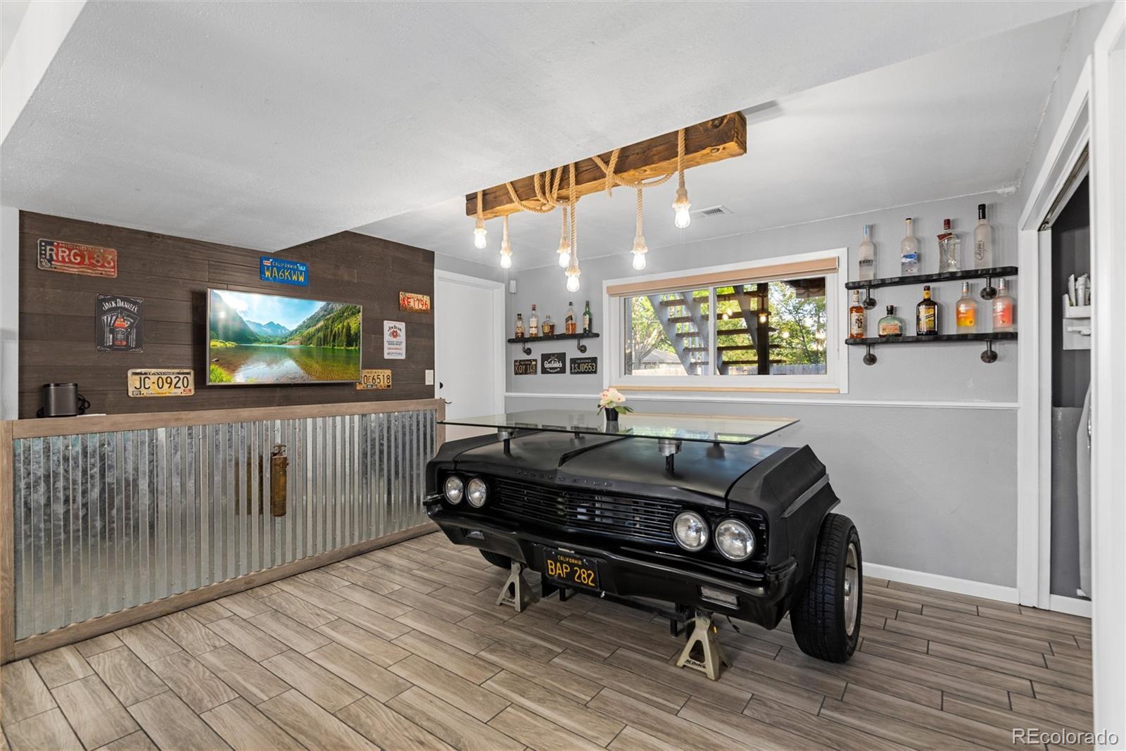 4904 West 61st Drive Arvada, CO 80003 - Photo 22 of 37 a living room with furniture and a flat screen tv