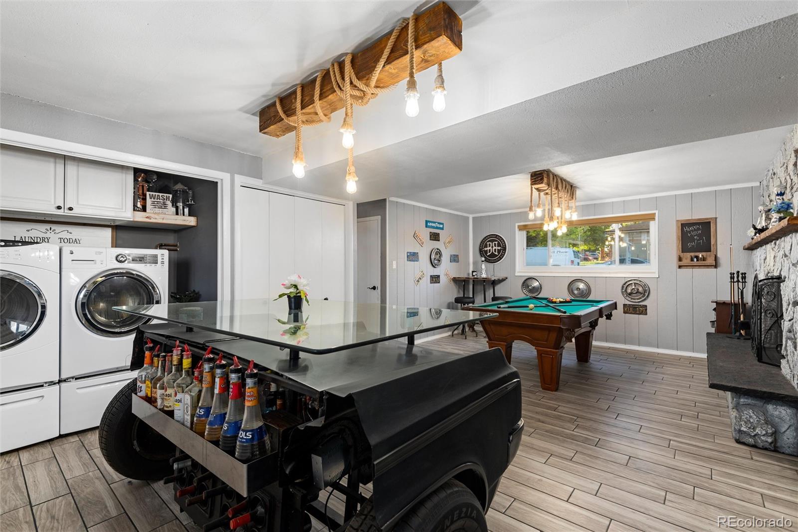 4904 West 61st Drive Arvada, CO 80003 - Photo 23 of 37 a living room with furniture a flat screen tv and windows