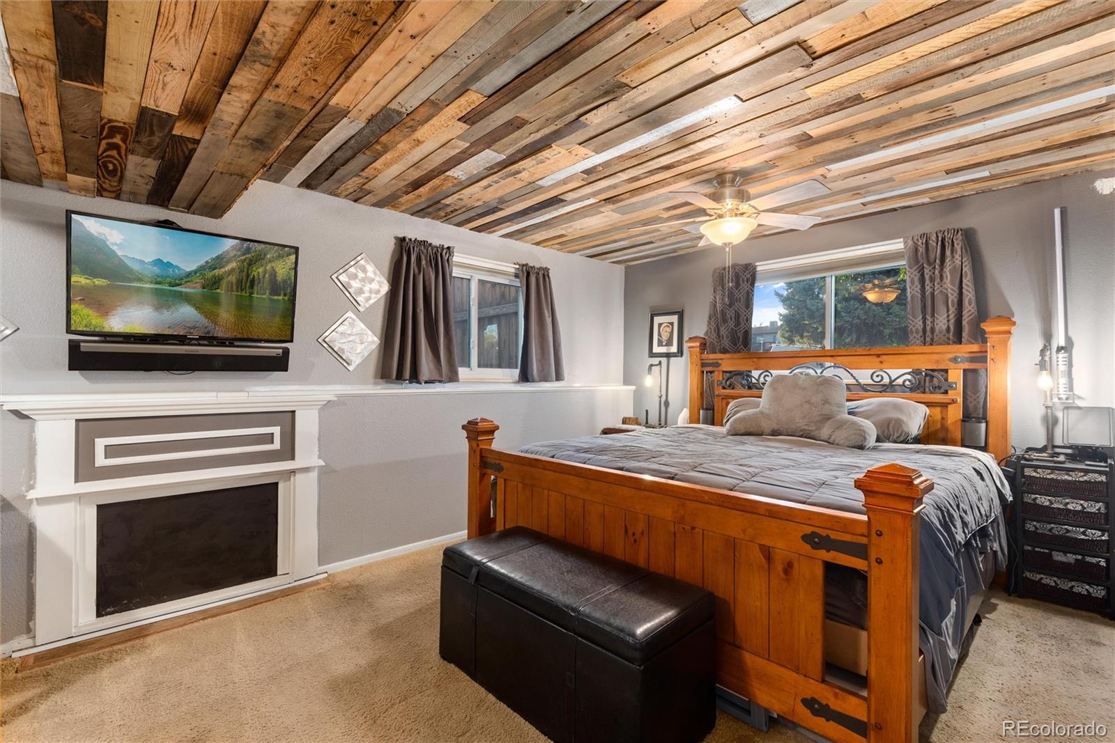 4904 West 61st Drive Arvada, CO 80003 - Photo 26 of 37 a bedroom with furniture and flat screen tv