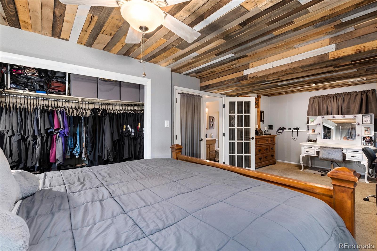 4904 West 61st Drive Arvada, CO 80003 - Photo 27 of 37 a bed room with a bed and a walk in closet