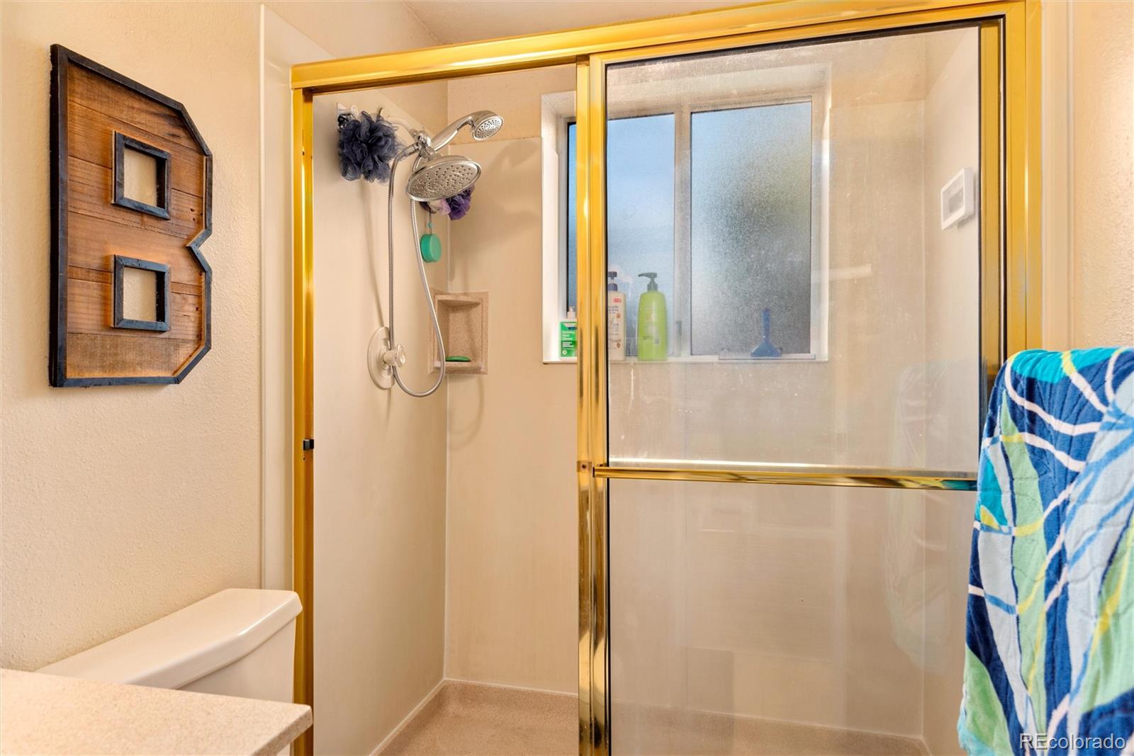 4904 West 61st Drive Arvada, CO 80003 - Photo 29 of 37 a bathroom with a shower and a toilet
