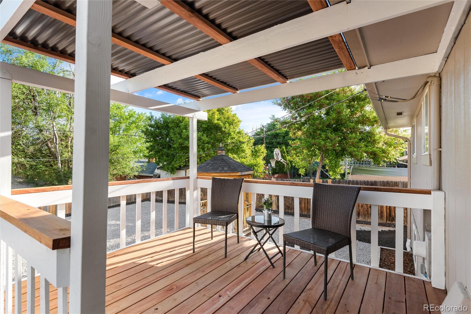 4904 West 61st Drive Arvada, CO 80003 - Photo 30 of 37 a view of balcony with chairs and wooden floor