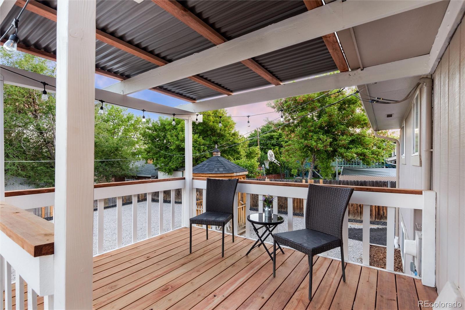 4904 West 61st Drive Arvada, CO 80003 - Photo 31 of 37 a view of a patio with table and chairs and wooden floor