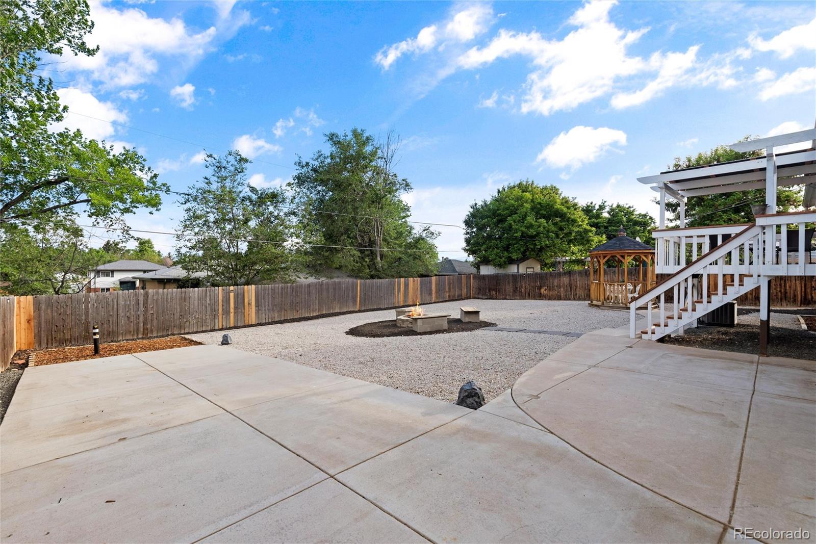 4904 West 61st Drive Arvada, CO 80003 - Photo 32 of 37 a view of backyard with deck and trees