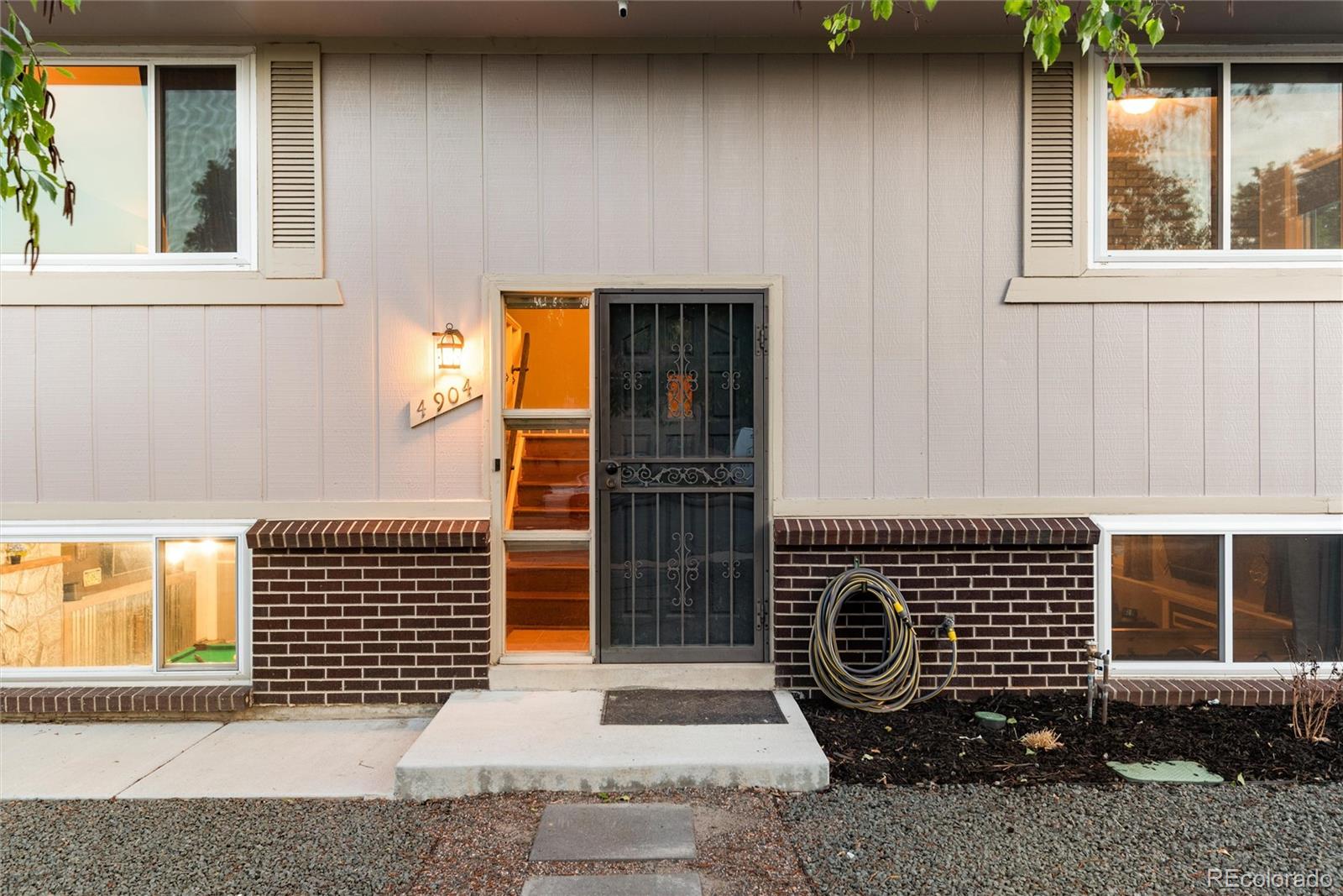 4904 West 61st Drive Arvada, CO 80003 - Photo 5 of 37 a front view of a house with a window