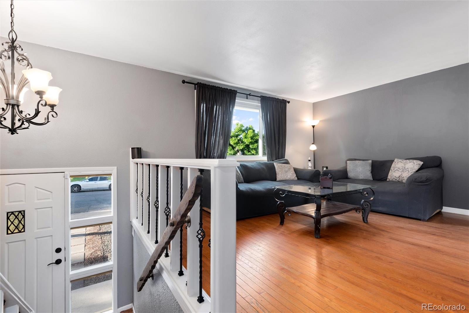 4904 West 61st Drive Arvada, CO 80003 - Photo 7 of 37 a living room with furniture and wooden floor