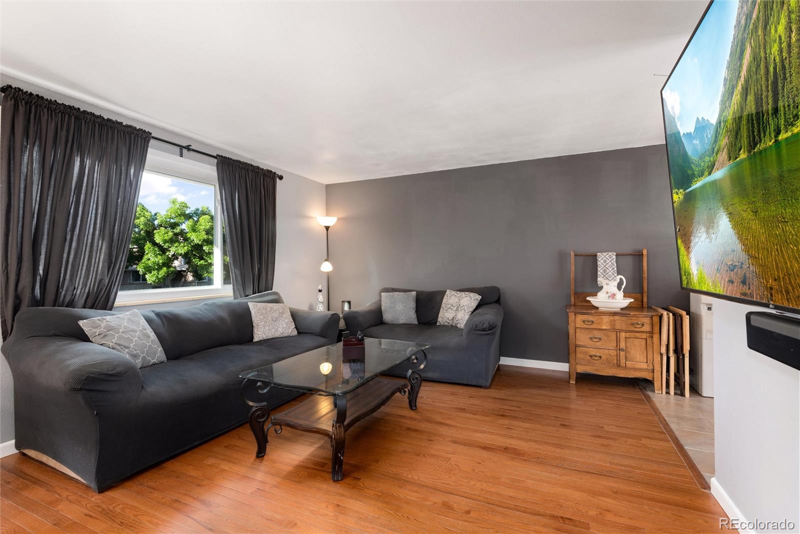 4904 West 61st Drive Arvada, CO 80003 - Photo 8 of 37 a living room with furniture and a large window