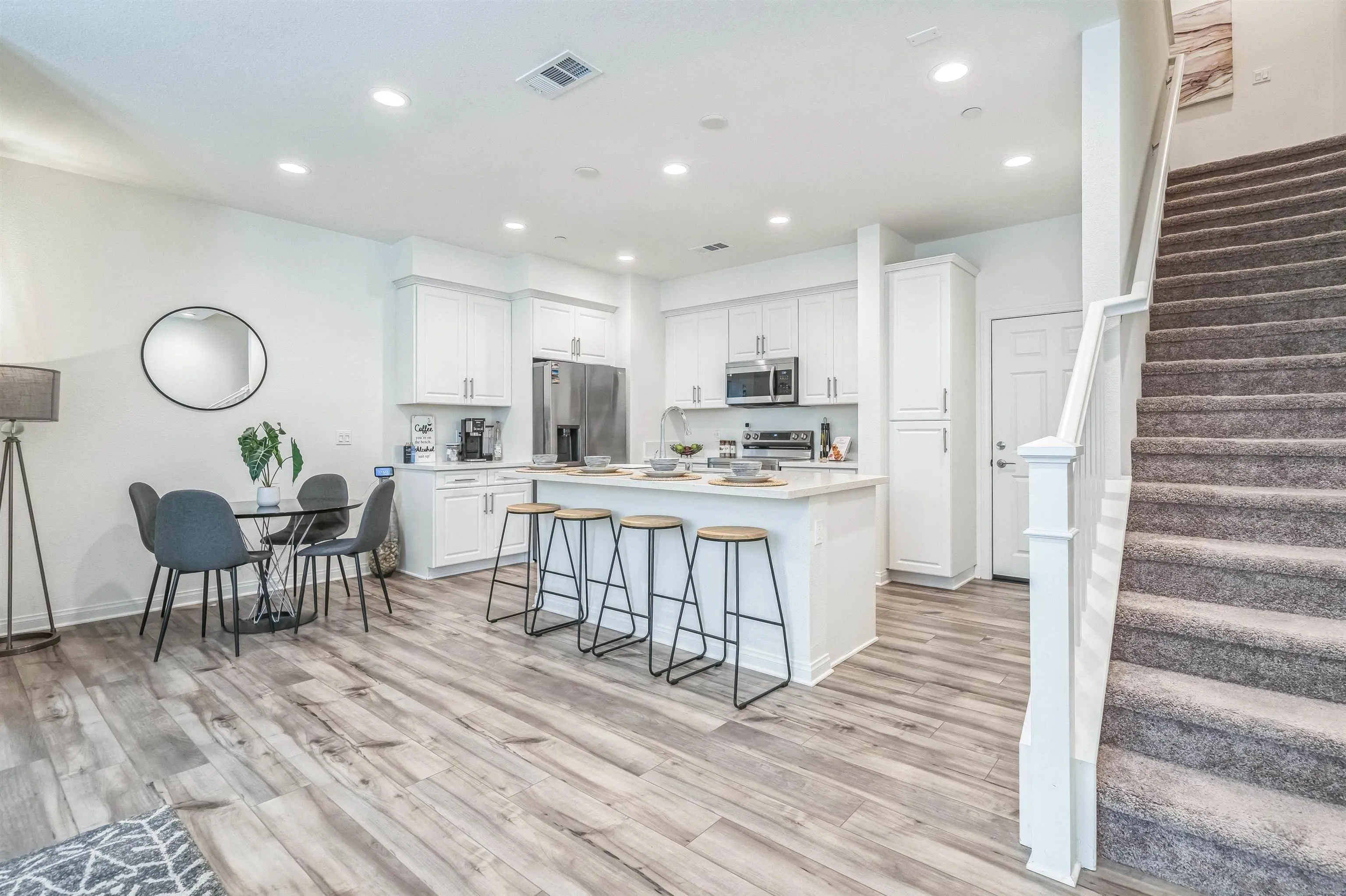 2018 Barite Street Spring Valley, CA 91977 - Photo 10 of 47 a kitchen with stainless steel appliances kitchen island granite countertop a stove a sink a refrigerator cabinets and a dining table